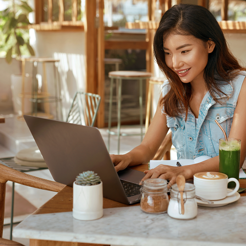 Digital nomad In Jeans Outfit Working At Coffee Shop