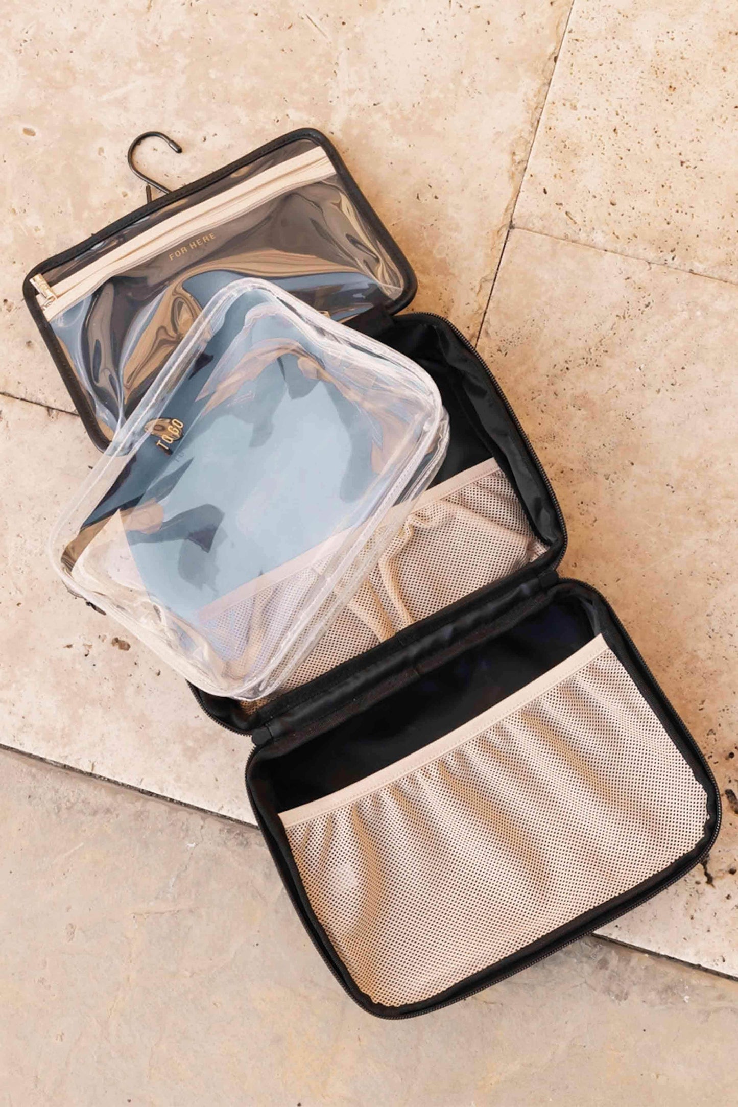 hanging cosmetic case in black, showing all pockets and compartments