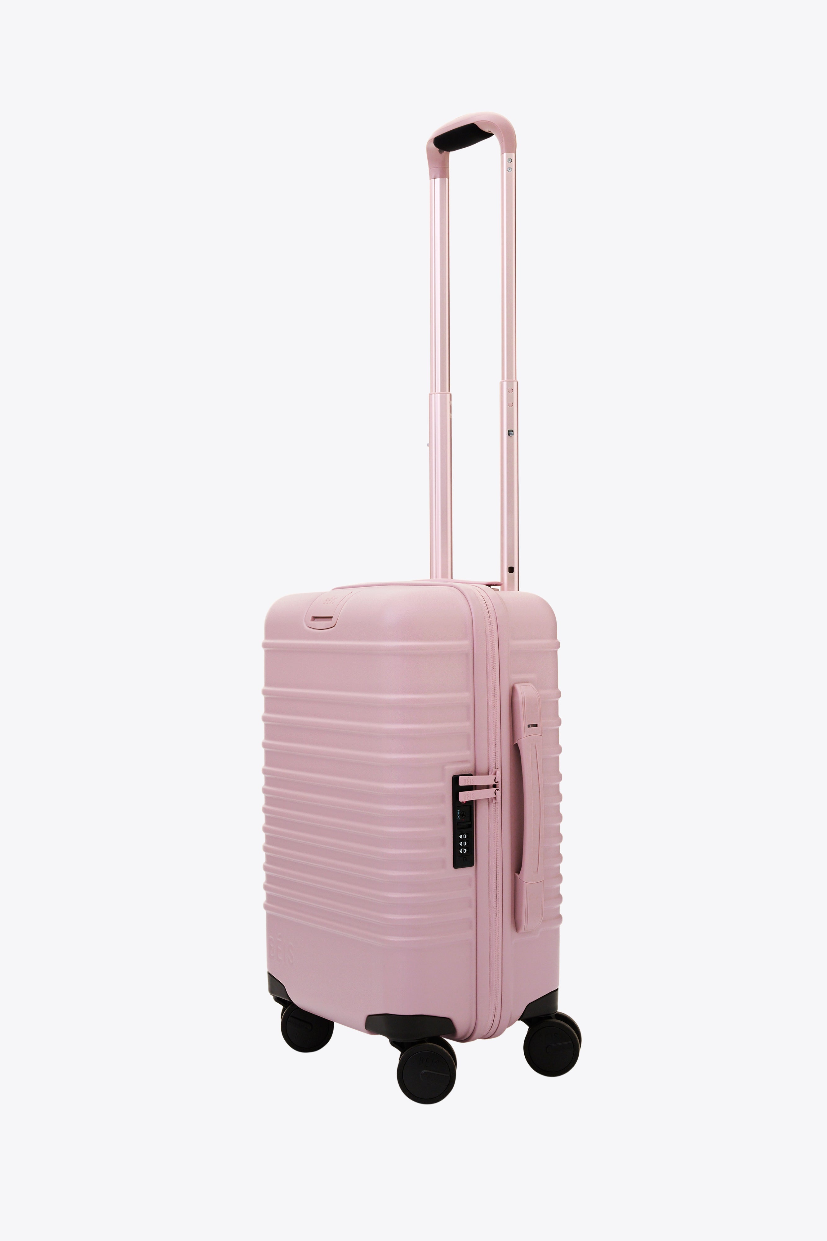 Pink rolling luggage on sale